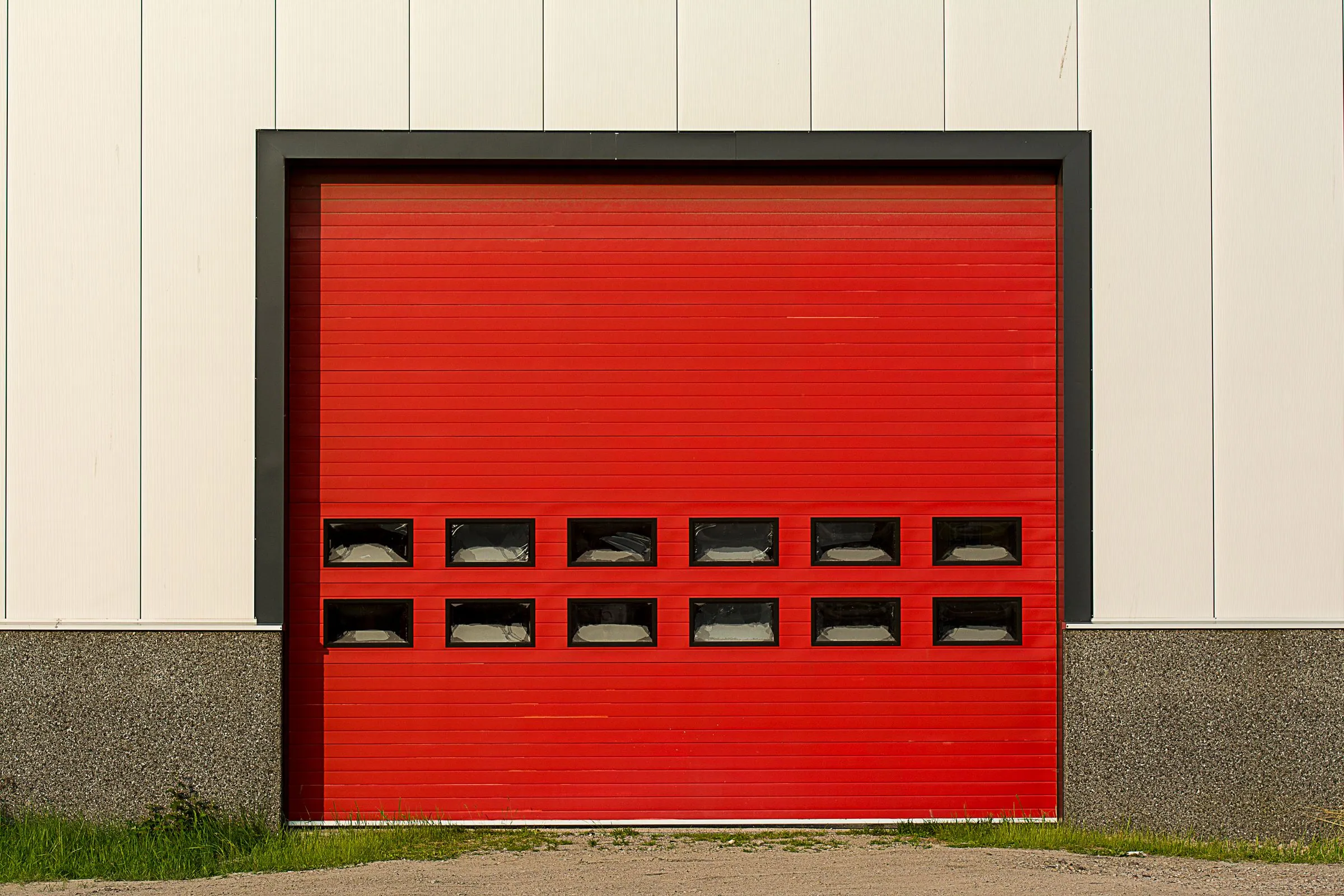 Bright red roller shutter door on an industrial building